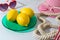 Summer modern creative background with lemons on colorful plate and beach accessories