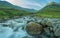 A summer morning by a flowing river and stone bridge in the heart of the Lake District