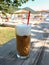 Summer morning with freddo cappuccino greek cold coffee drink on the backgraund straw umbrellas and sunbeds of Antisamos beach,