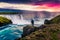 Summer morning scene on the Godafoss Waterfall with photographer. Colorful sunrise on the on Skjalfandafljot river, Iceland, Europ