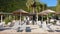 Summer morning straw umbrellas and sunbeds, palm trees on a beautiful Antisamos beach of Kefalonia island, Ionian sea, Greece