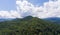 Summer mountain landscape. Forested mountains and clouds.