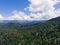 Summer mountain landscape. Forested mountains and clouds.