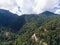 Summer mountain landscape. Forested mountains and clouds.