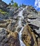 Summer mountain landscape of Shirlak waterfall in rocks of Altai