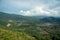 Summer mountains green grass, blue sky and village landscape, view from mountain peak at Broga Hill, Malaysia