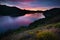 Summer mountains landscape with lake in sunset