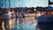 summer night in Yacht harbor blurred sea and city light reflection people silhouette relax in cafe on promenade