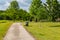 Summer in Omaha, Green lawn, paved trail and a jogger at Ed Zorinsky Lake Park Omaha NE