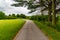 Summer in Omaha, Paved trail with a bench at a bend at Ed Zorinsky lake park, Omaha, Nebraska