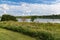 Summer in Omaha, Two boaters canoers in kayaks with Shoreline and sky reflections in the lake at Ed Zorinsky Lake Park Omaha NE