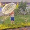 Summer outdoor activities. Children playing outdoor on front yard. Boy with umbrella having fun near automatic plant