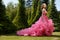 Summer outdoor photoshoot of beautiful woman in the luxury evening dress