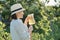 Summer outdoor portrait of woman with natural drink made from strawberry mint herbs, woman gardening