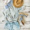 Summer outfit flatlay, parquet background, top view, square crop