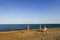 Summer is over. Umbrellas and a deckchair on a sunny empty beach without people