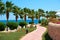 Summer palm trees on the coastal promenade overlooking in hotel outdoors the red sea, travel concept in Egypt, Sharm El