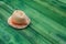 Summer panama straw hat on green wood table