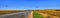 Summer panorama of the highway among the fields