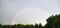 Summer panorama of rainbow after the rain