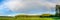 Summer panorama with a semicircle of a rainbow