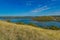 Summer panoramic idyllic nature landscape scenic view of river surrounded by hill land outdoor environment and blue sky horizon