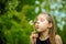 Summer in park or forest. nature, freshness idea and freedom. happy childhood.Summer joy, little girl blowing dandelion