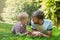 Summer photo happy father and son together lying on green grass