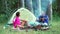 Summer picnic. Couple having camp in forest. Forest vacation concept.