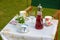 Summer picnic table set with cups and saucers