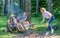 Summer picnic. Tourists hikers sit on log relaxing waiting picnic snack. Company having hike picnic nature background