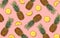 Summer pineapple fruit pattern on a pink background