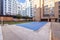 A summer pool covered with canvas to spend the winter in the common areas of an urbanization with gardens, trees and terrazzo