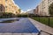 A summer pool covered with canvas to spend the winter in the common areas of an urbanization with green lawn gardens, trees,