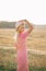 Summer portrait of a girl in a straw hat in a field. Landscape in a yellow wheat field