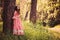 Summer portrait of happy child girl dressed in pink fairytale princess dress