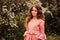 Summer portrait of happy child girl dressed in pink fairytale princess dress in forest