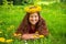 Summer portrait of a merry child with dandelions flowers.