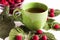 Summer raspberry tea in green cup. Herbal tea served with fresh raspberry leaves
