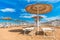 Summer recreation. Straw sun umbrellas on beach.