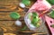 Summer refreshing cocktail of watermelon, green mint and ice water on a wooden background in a glass with frost