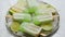 Summer refreshing homemade lime popsicles with chipped ice over stone background