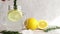 Summer refreshment drinks. A woman's hand adding bunch of rosemary into a fresh homemade citrus lemonade in jar