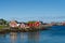 Summer in Reine, Lofoten Islands, Norway. Popular tourist destination. Old fishermans village with wooden red cottages