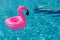 Summer sale. Pink inflatable flamingo in pool water for summer beach background. Minimal summer concept