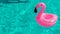 Summer sale. Pink inflatable flamingo in pool water for summer beach background. Minimal summer concept