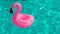 Summer sale. Pink inflatable flamingo in pool water for summer beach background. Minimal summer concept