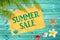 Summer sale written on yellow sign, blue wooden planks, seashells, palm tree background
