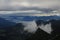 Summer scene in Switzerland. Mountain ranges, fog and clouds on a morning after rainfall. View from Brienzer Rothorn.