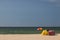 Summer scenery, sunny beach. Umbrella and beach tent. Sandy coastline